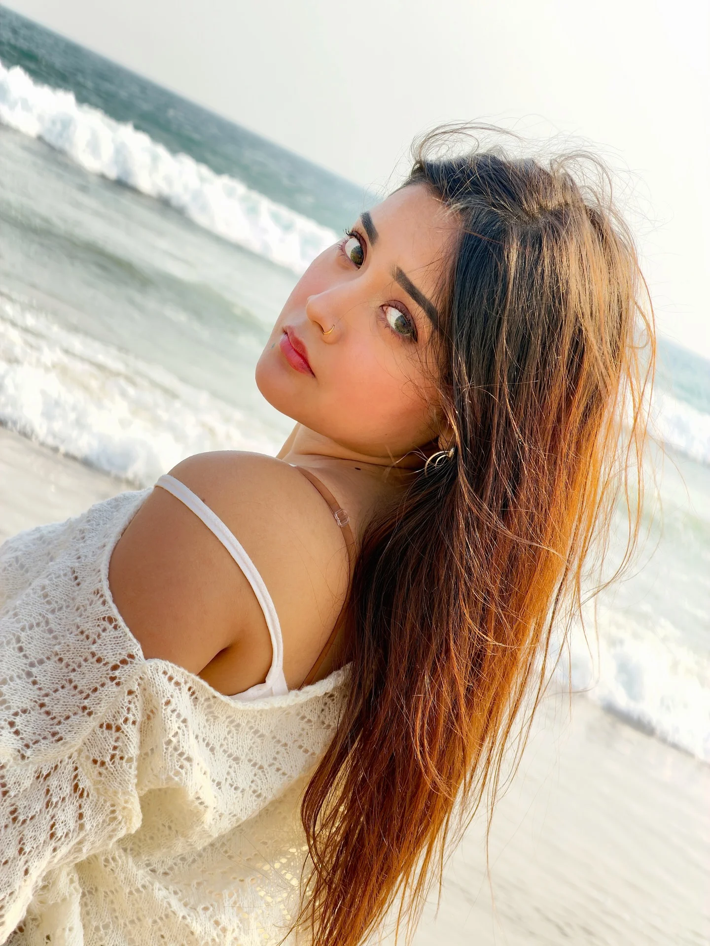 Photo by Aimi Gogoi on February 15, 2026. May be an image of one or more people, long hair, makeup, beach and text.