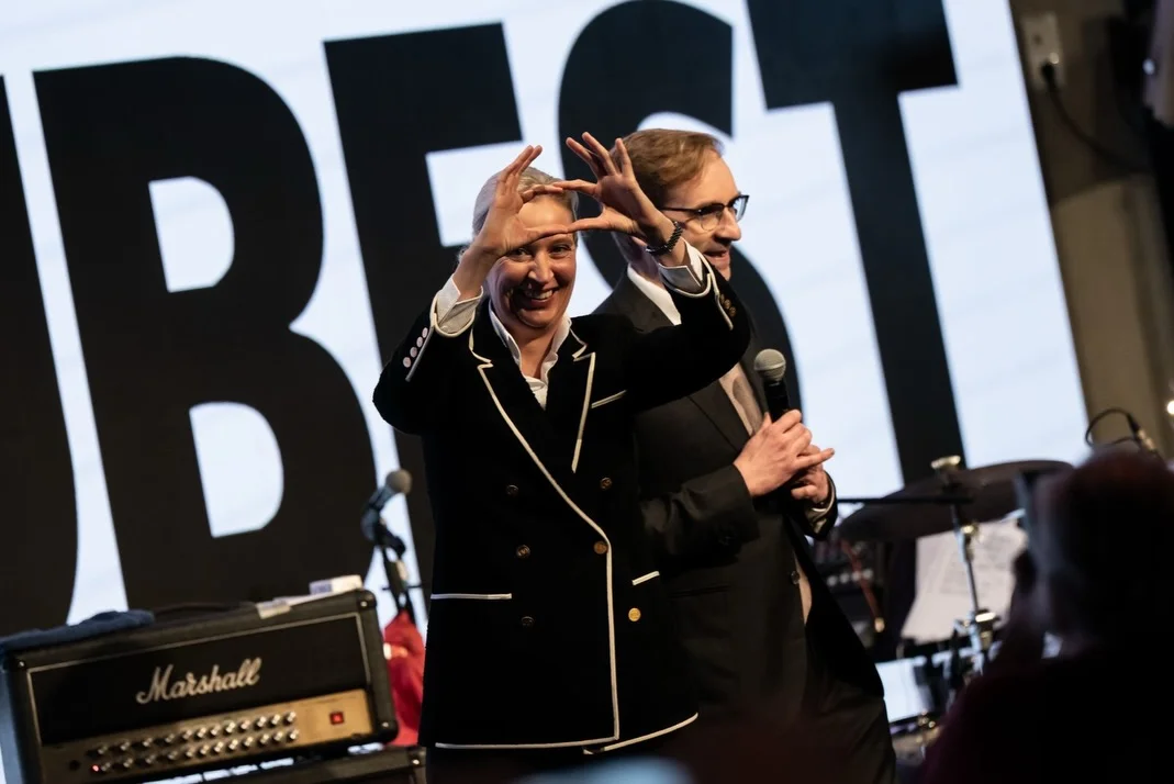 Photo by Alice Weidel on February 17, 2026. May be an image of saxophone, microphone, concert and text.