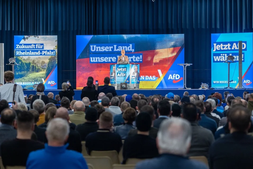 Photo by Alice Weidel on February 21, 2026. May be an image of crowd, dais and text that says 'Hく茶 Zukunftfür für Rheinland-Pfalz! Pfalz! Unser UnserLand, Land, unsere unsereVirte! purte! WIRREGELNTA WIRREGELHNAAFt REGELN AfD Jetzt AfD! JetztAl D wäł NDAS AfD WIR WIRREGEL WIRREGELCDASAD REGEL DAS AfD'.