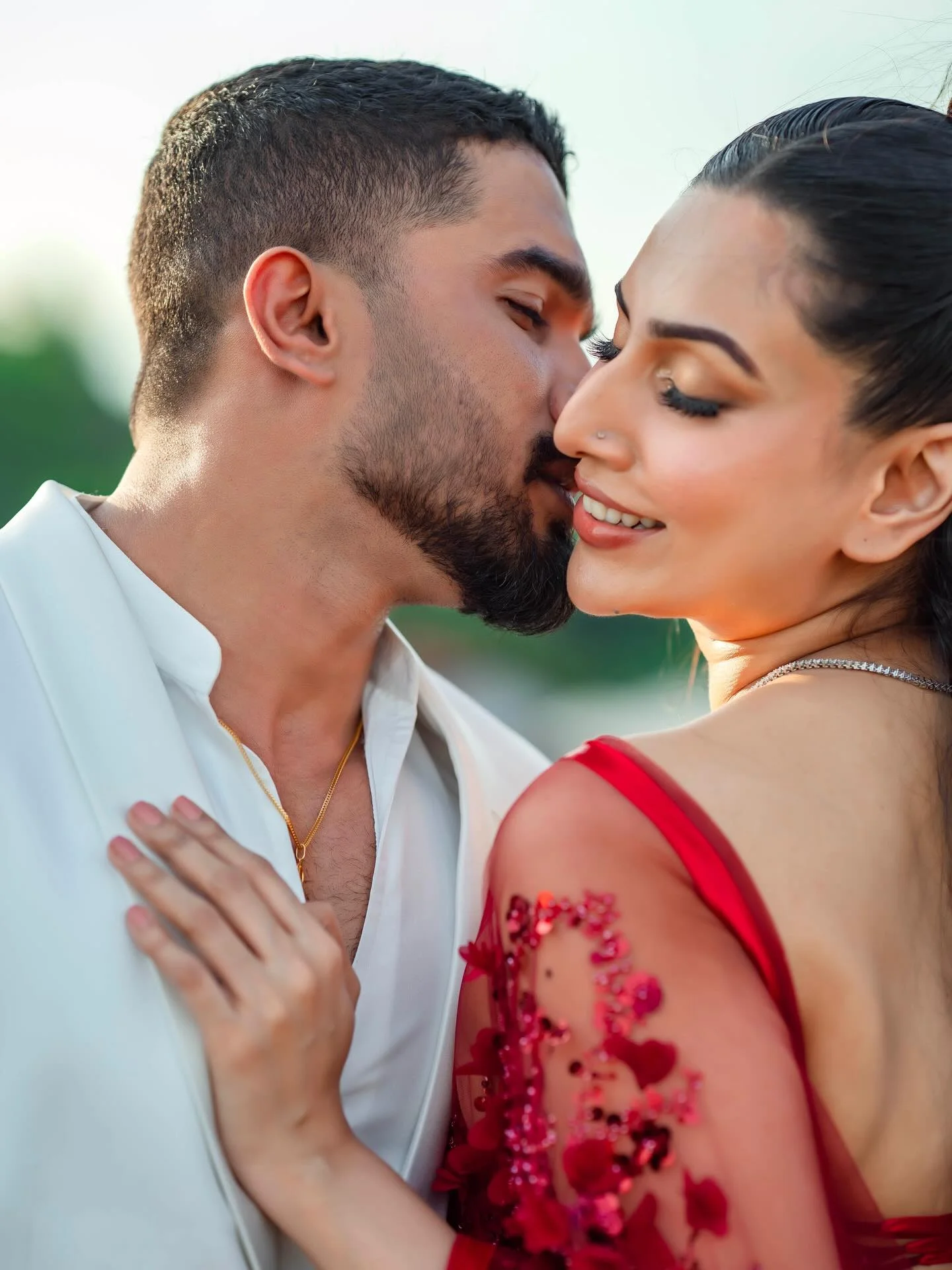 Photo by Amanda Silva on February 14, 2026. May be an image of one or more people, makeup, people kissing, dress, wedding, outdoors and text.