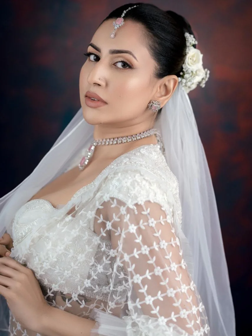 Photo shared by Amanda Silva on March 21, 2026 tagging @designer__flowers, @uditha_umesh, and @niroshandhilshan. May be an image of one or more people, makeup, dress, wedding and text.